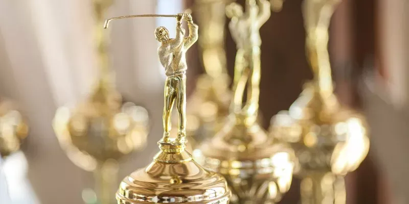A row of gold trophy awards ready for engraving and presentation
