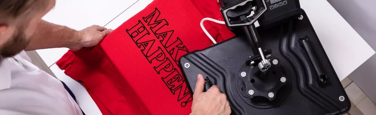 A decorator heat-pressing a design onto a t-shirt